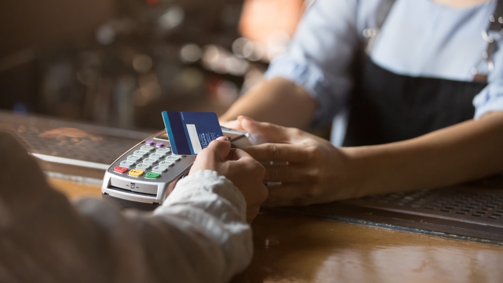 New business owner processing card payment from customer