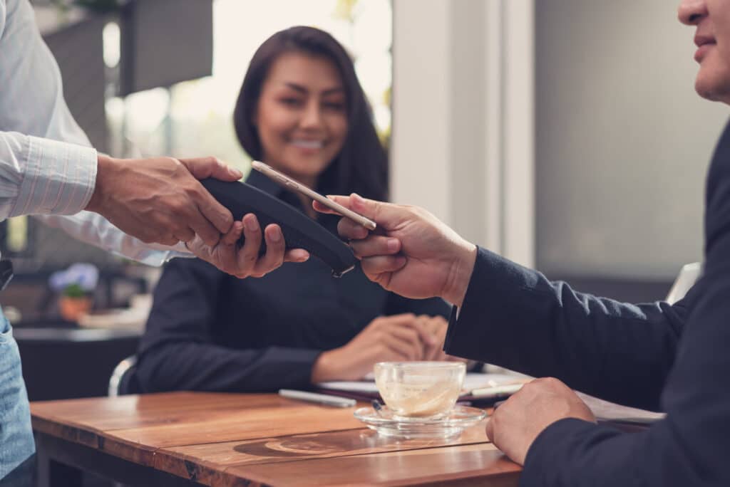 man paying for coffee with mobile POS system