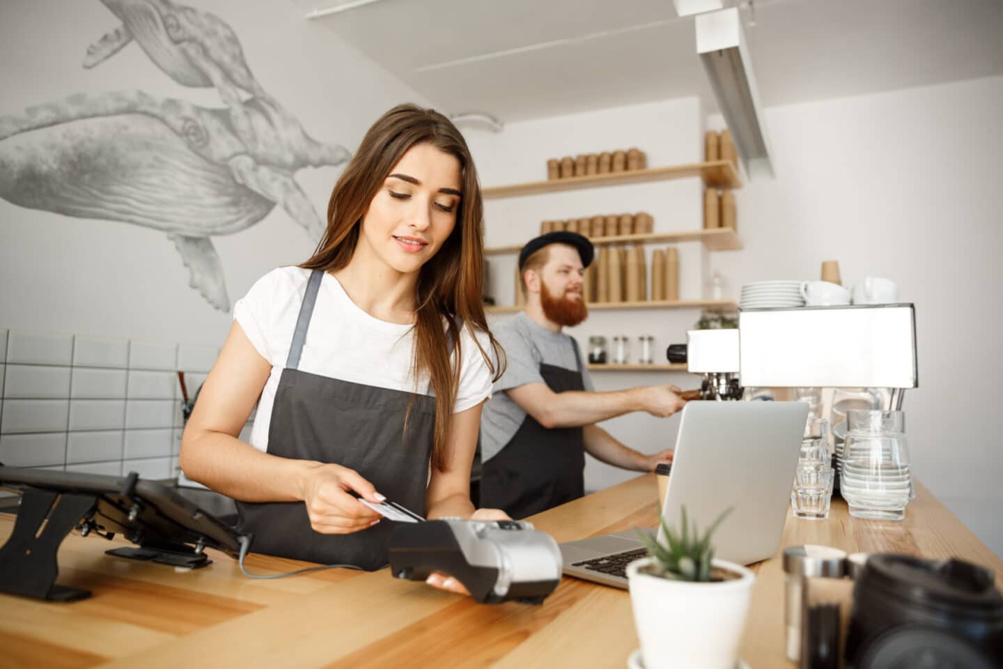 Barista using POS System at coffee shop