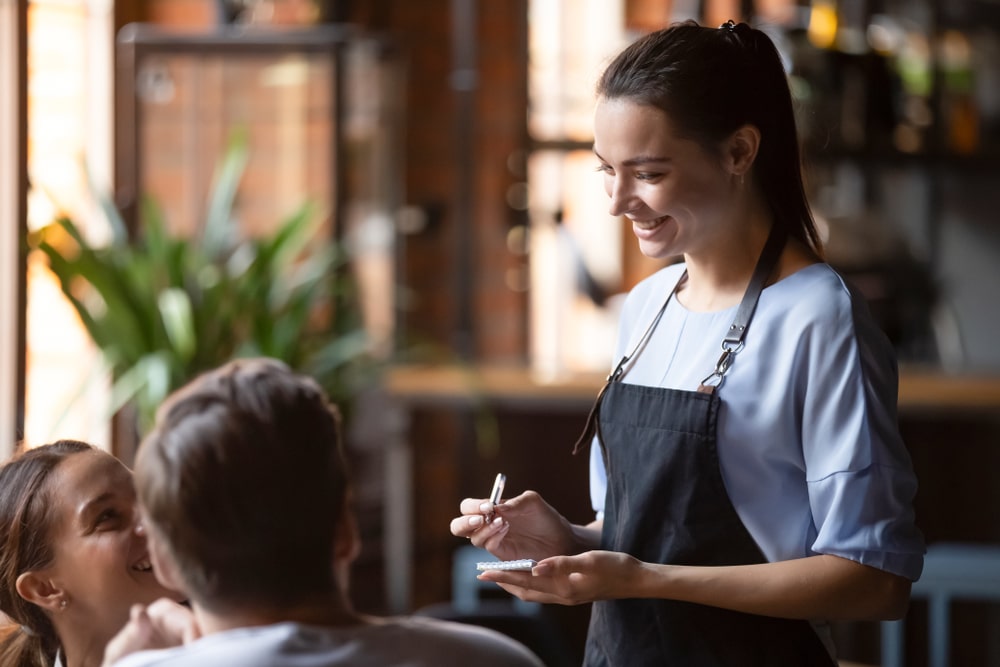 Female waitress taking order with user friendly POS system